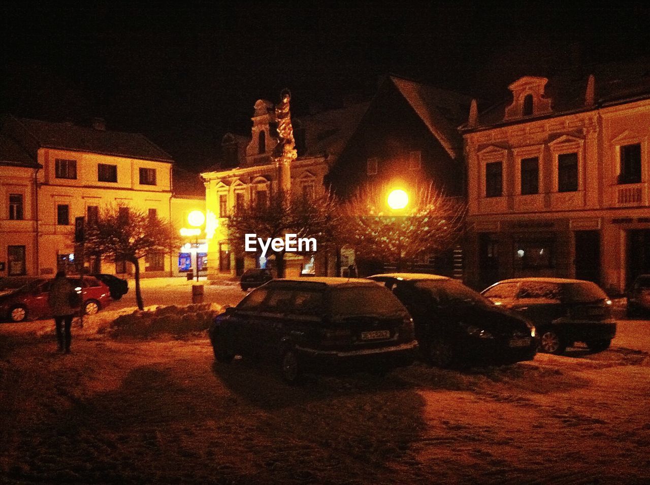 VIEW OF ILLUMINATED CITY STREET AT NIGHT