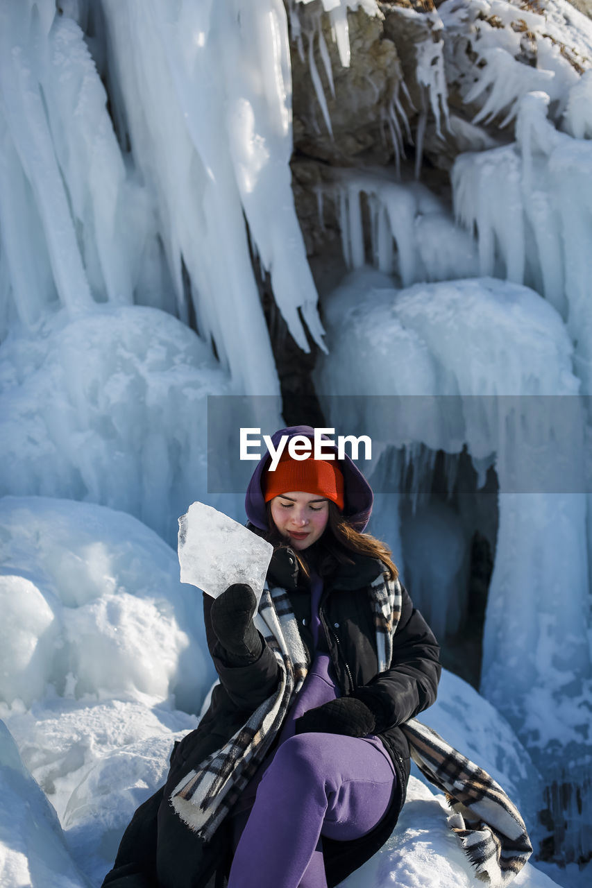 portrait of smiling woman standing on snow