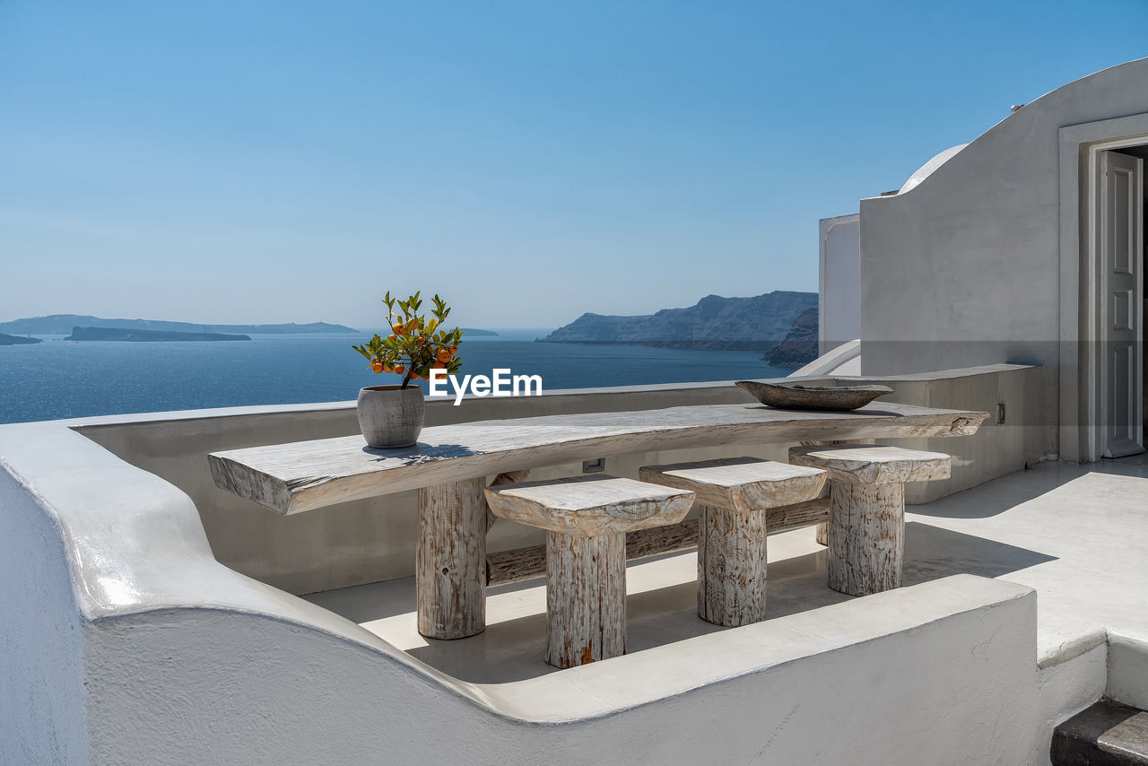 SCENIC VIEW OF SEA AND TABLE AGAINST CLEAR SKY