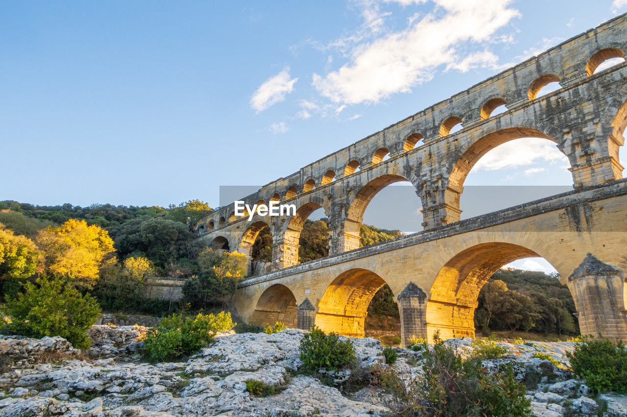 Famous pont du gard at setting sun. ancient roman three-tiered aqueduct bridge. ,france.