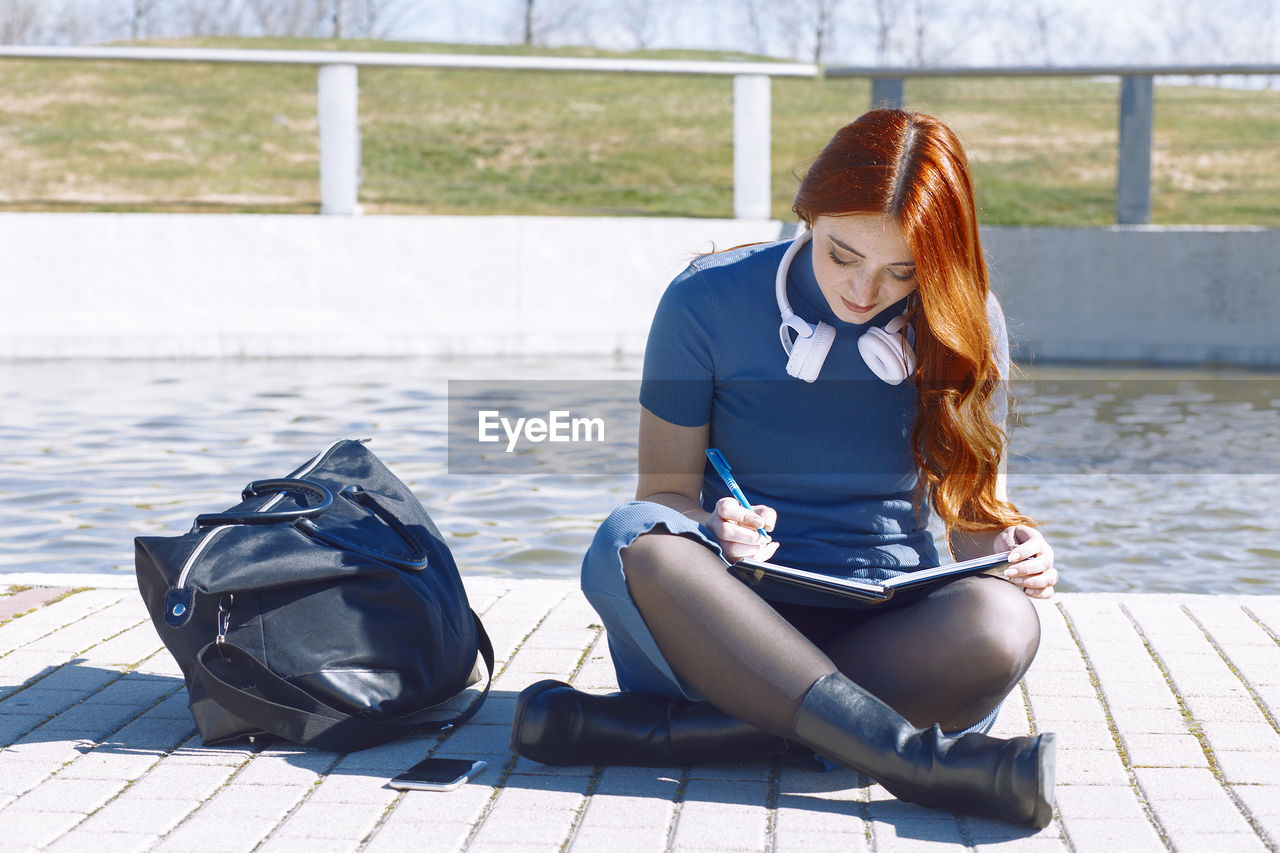 Young girl studying outside the campus