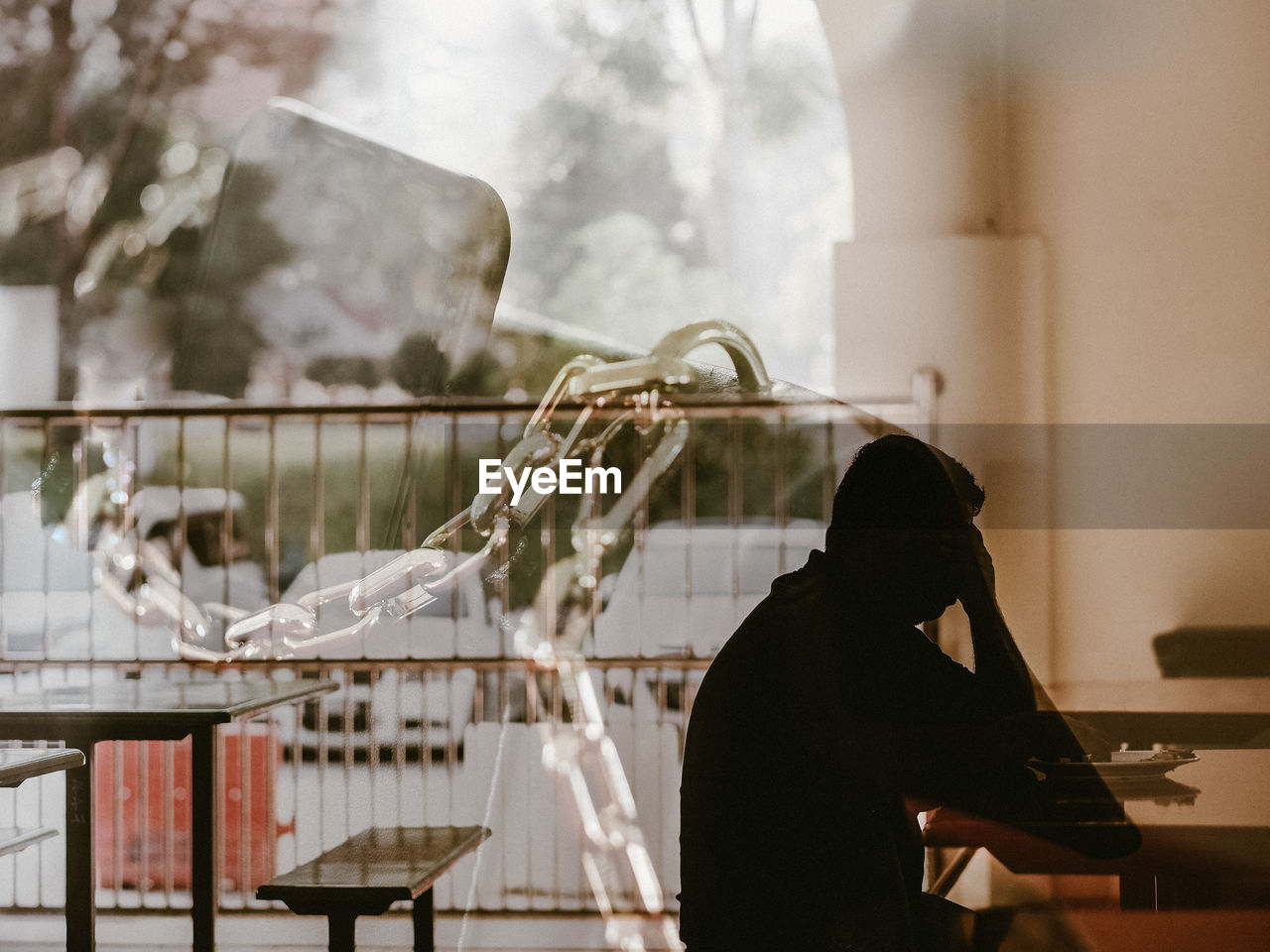 Side view of a man in deep thought by the window