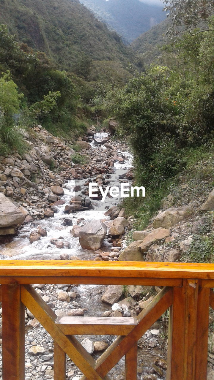 VIEW OF STREAM FLOWING THROUGH ROCKS