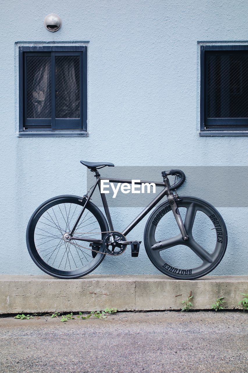 BICYCLE PARKED OUTSIDE HOUSE