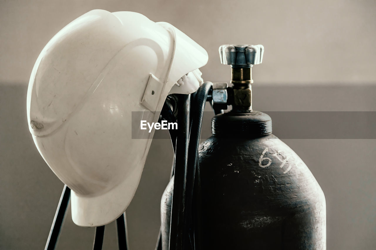 Close-up of hard hat on cylinder