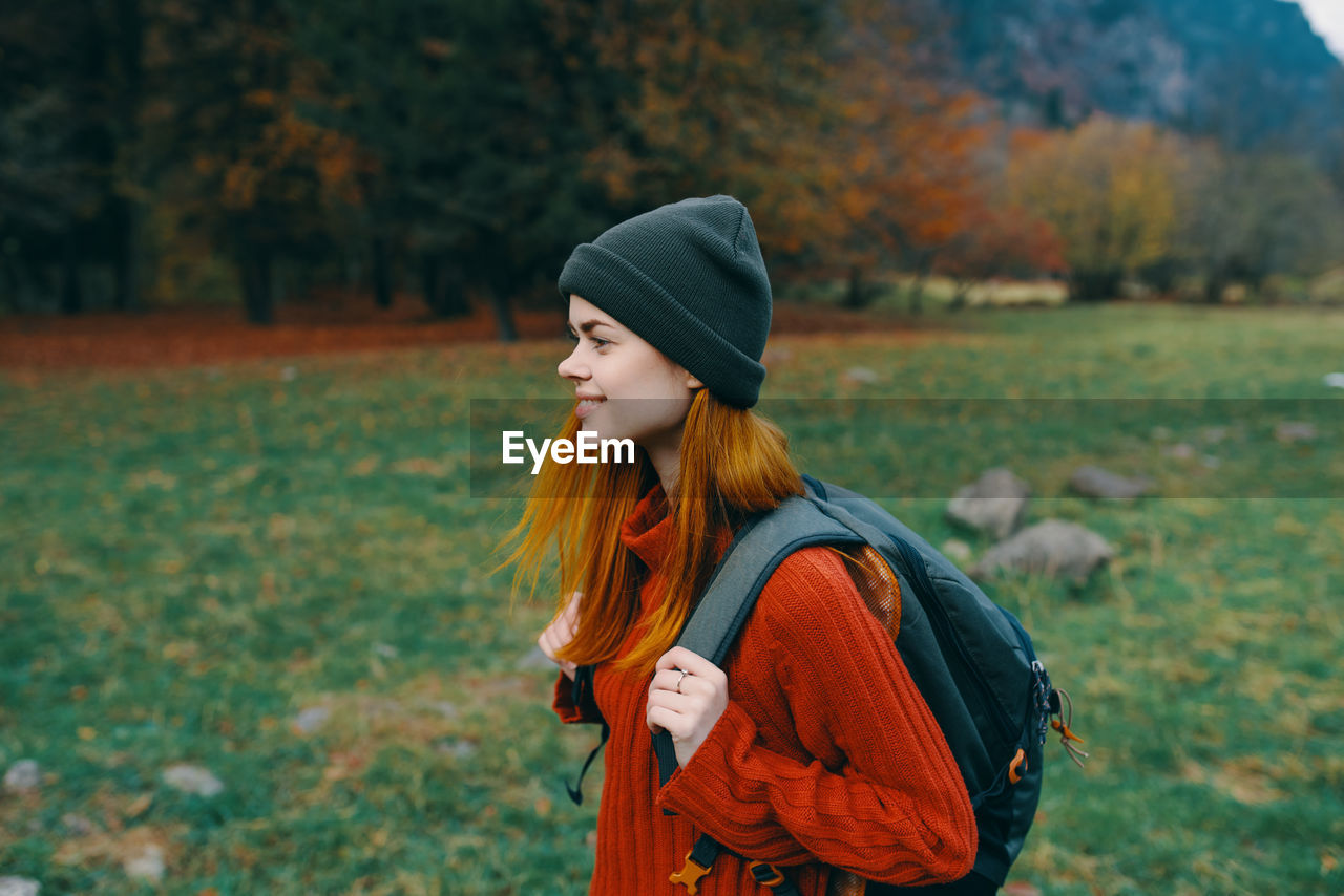 BEAUTIFUL YOUNG WOMAN STANDING ON LAND