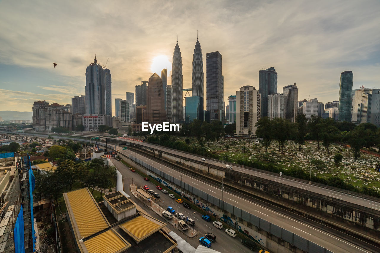 AERIAL VIEW OF BUILDINGS AGAINST CLOUDY SKY