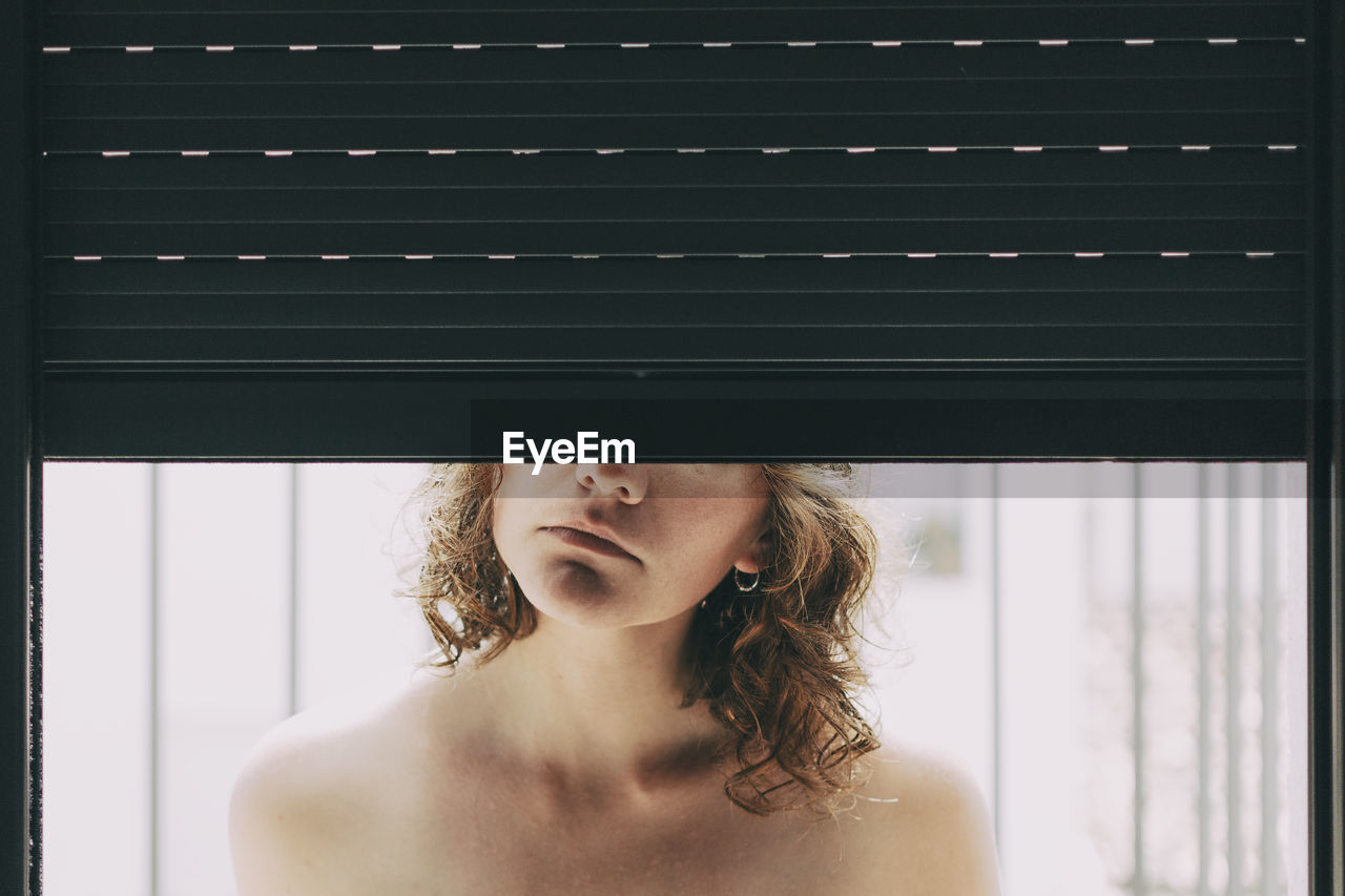 Close-up of woman by window