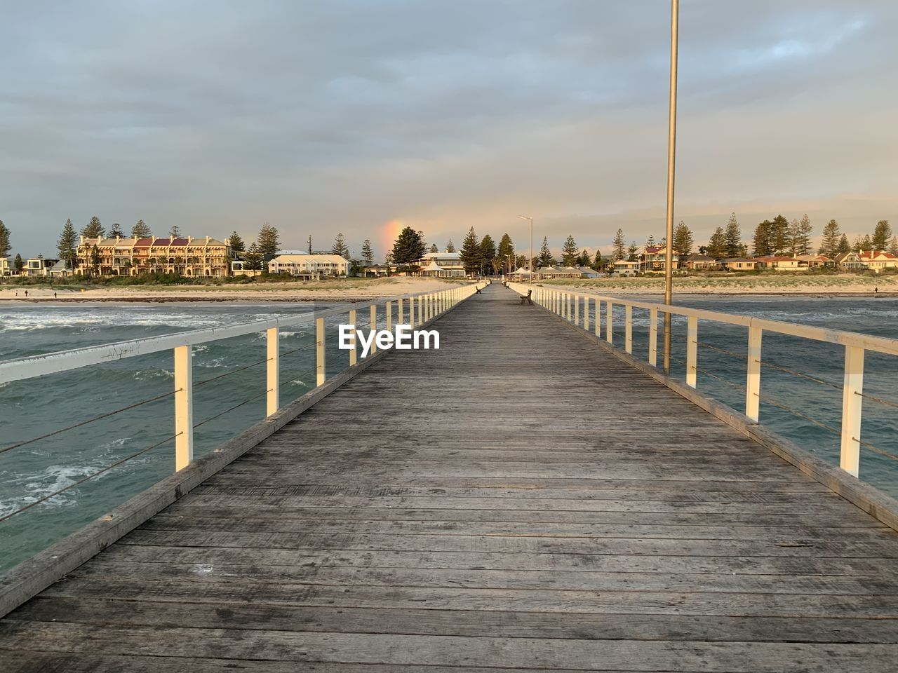 View of bridge over sea against cloudy sky