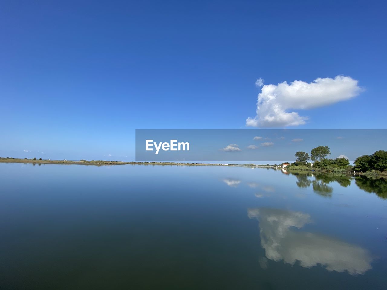 Scenic view of lake against blue sky