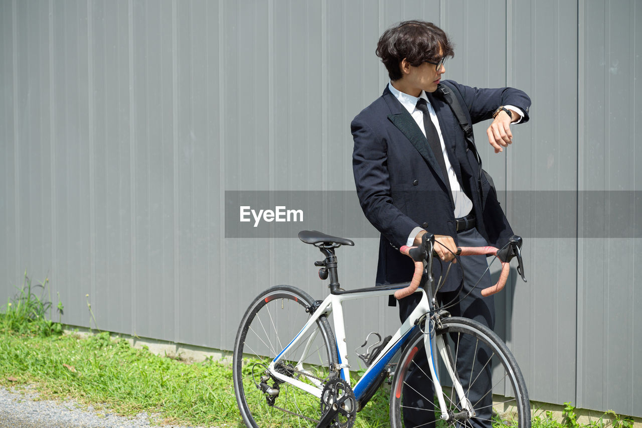 portrait of businessman riding bicycle