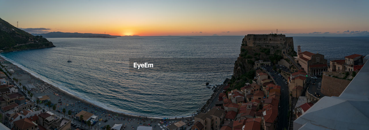 Scilla, view on the coastline, ruffo castle and on the sicily coast at sunset time