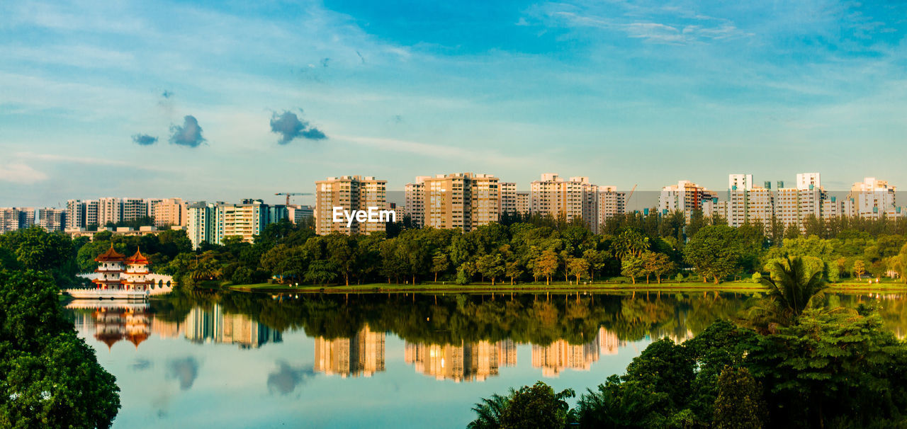 Reflection of trees and buildings in lake