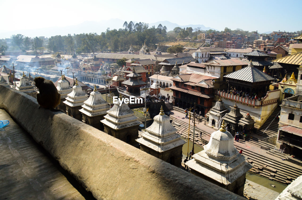 HIGH ANGLE VIEW OF BUILT STRUCTURES AGAINST SKY