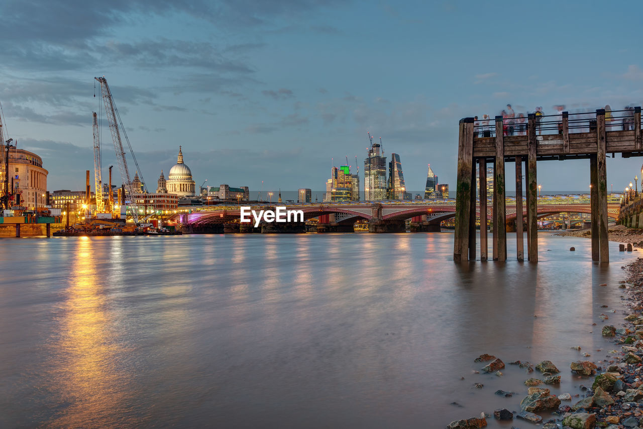 An old pier, the st pauls cathedral, blackfriars bridge and the city of london at dusk