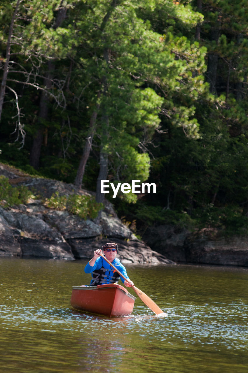 MAN IN BOAT ON RIVER