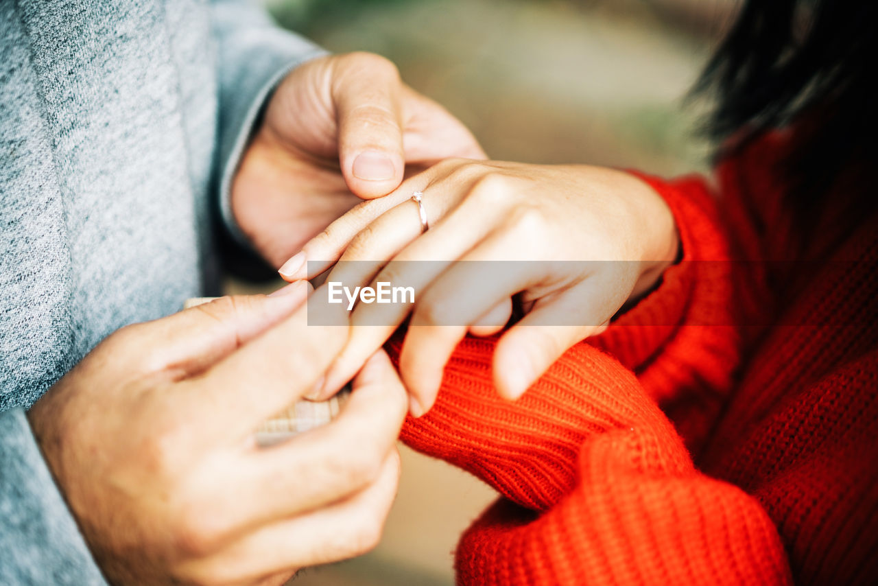 CLOSE-UP OF HANDS AND WOMAN