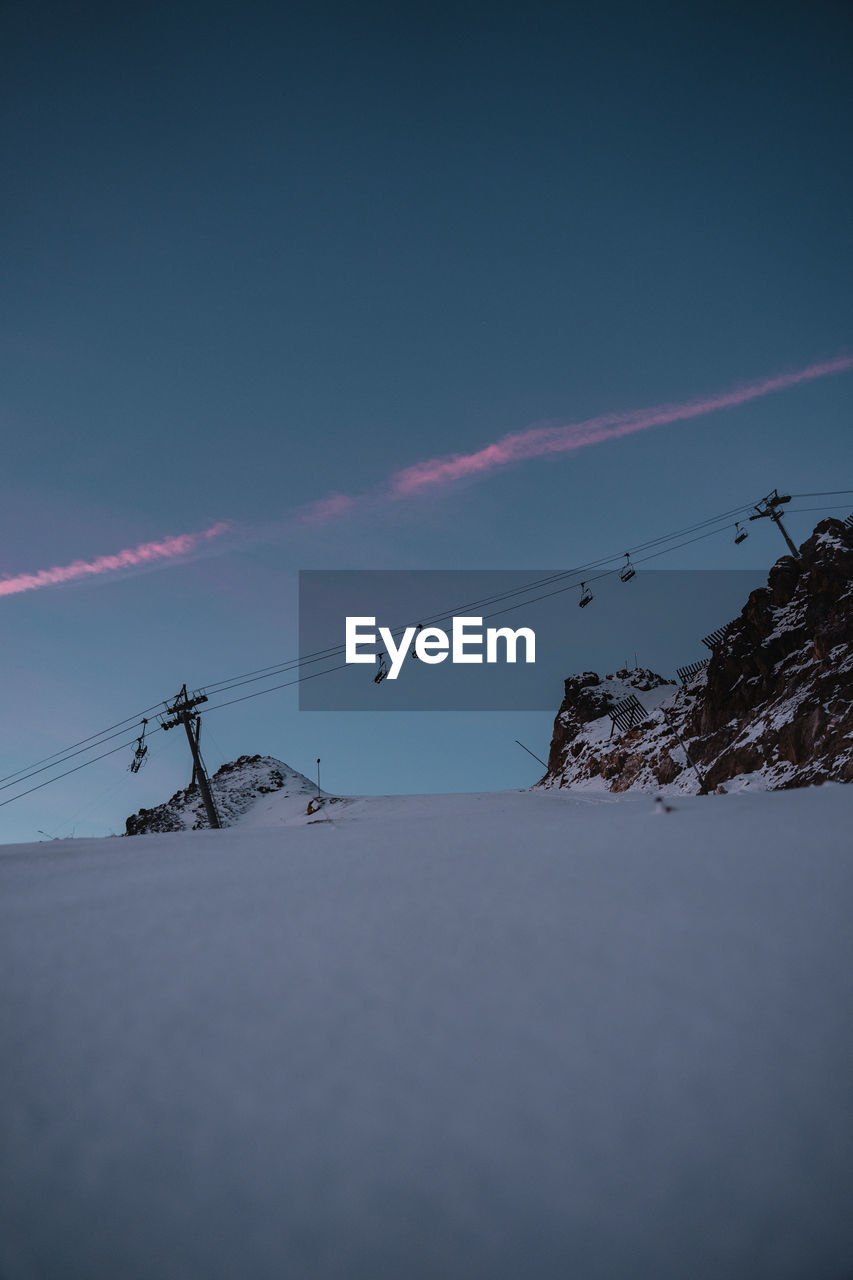 Low angle view of snowcapped mountain against sky