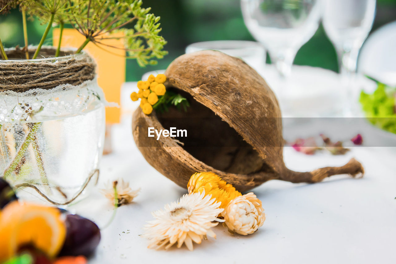 Decoration of the festive table with flowers and coconut. accessories made of natural materials 