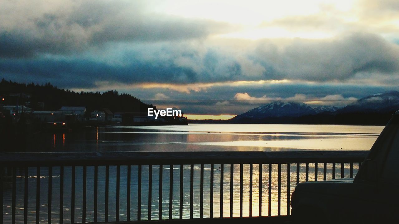 SCENIC VIEW OF MOUNTAINS AGAINST CLOUDY SKY AT SUNSET