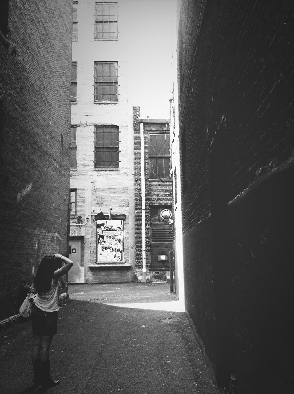 WOMAN STANDING IN FRONT OF BUILDING