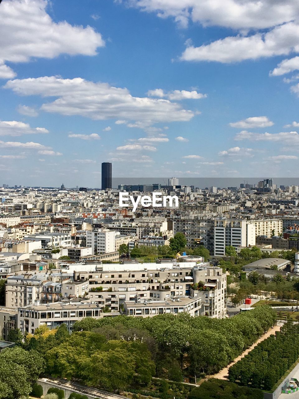 High angle view of trees and buildings in paris with view on montparnasse tower 