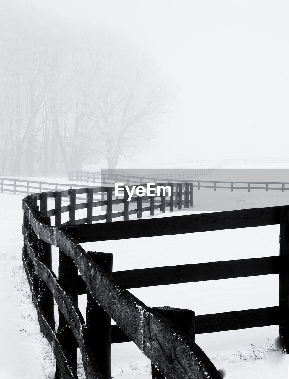 BRIDGE OVER SNOW COVERED LANDSCAPE