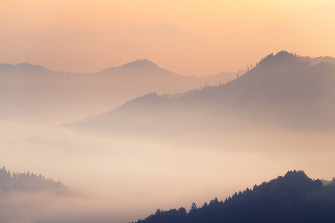 Scenic view of silhouette mountains against sky during sunset