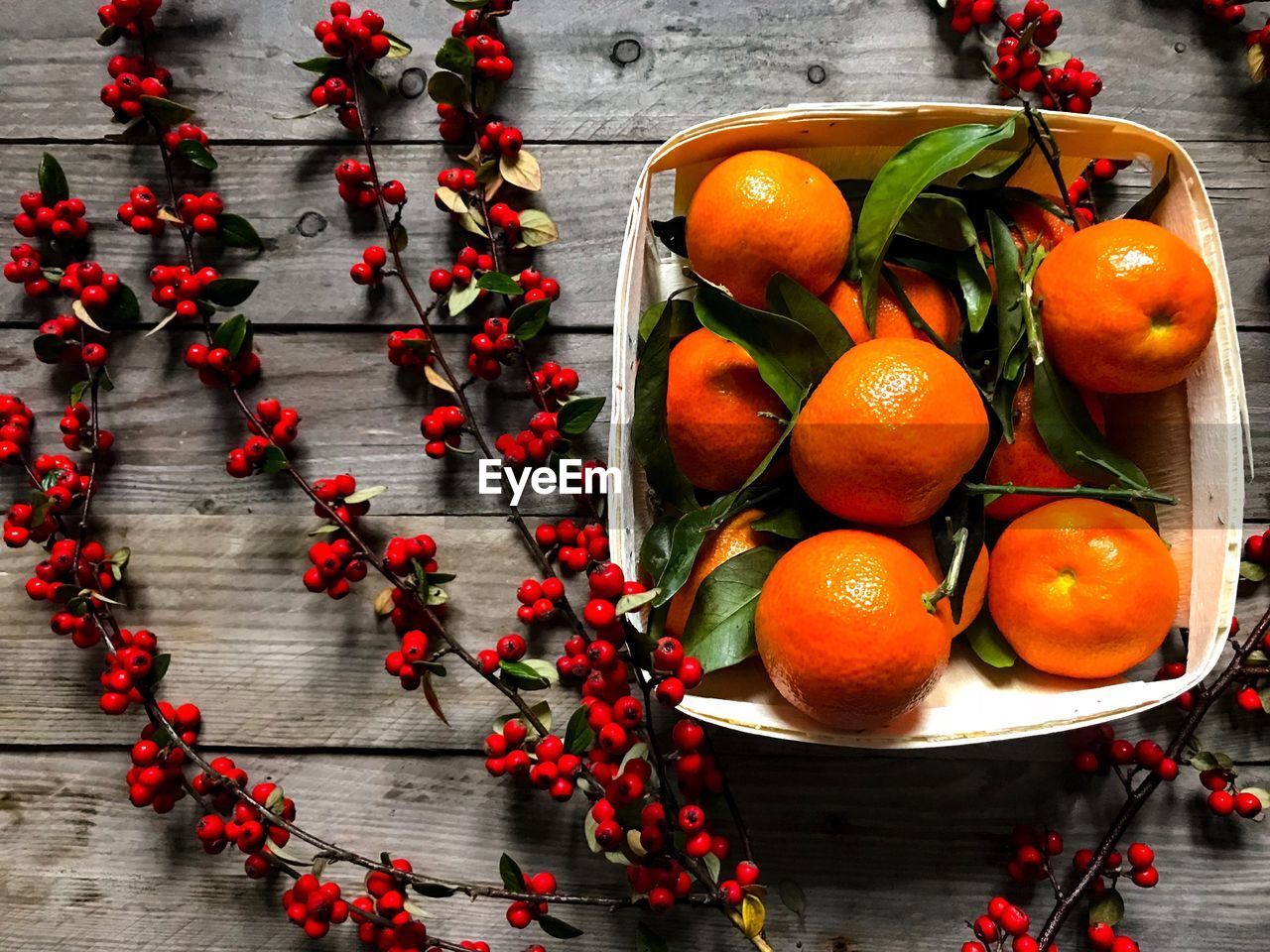 High angle view of orange fruits in basket on table