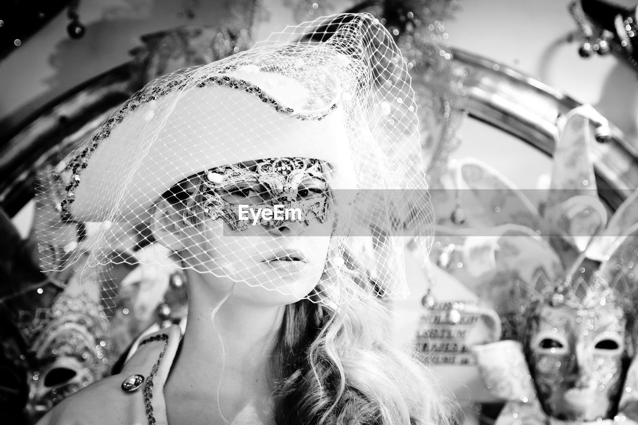 Portrait of young woman wearing eye mask in carnival