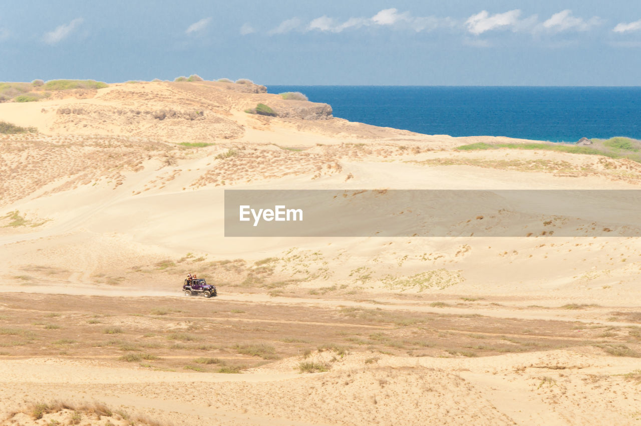 High angle view of desert by sea against sky