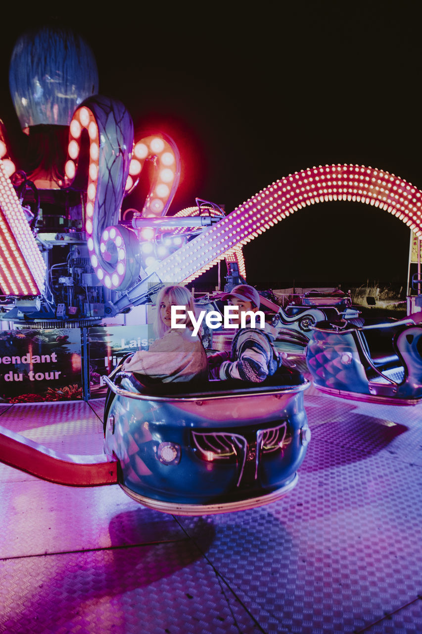 ILLUMINATED CAROUSEL AT AMUSEMENT PARK