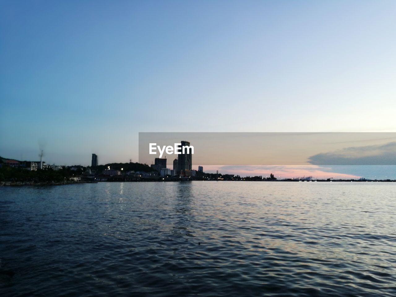 Scenic view of river against clear sky during sunset