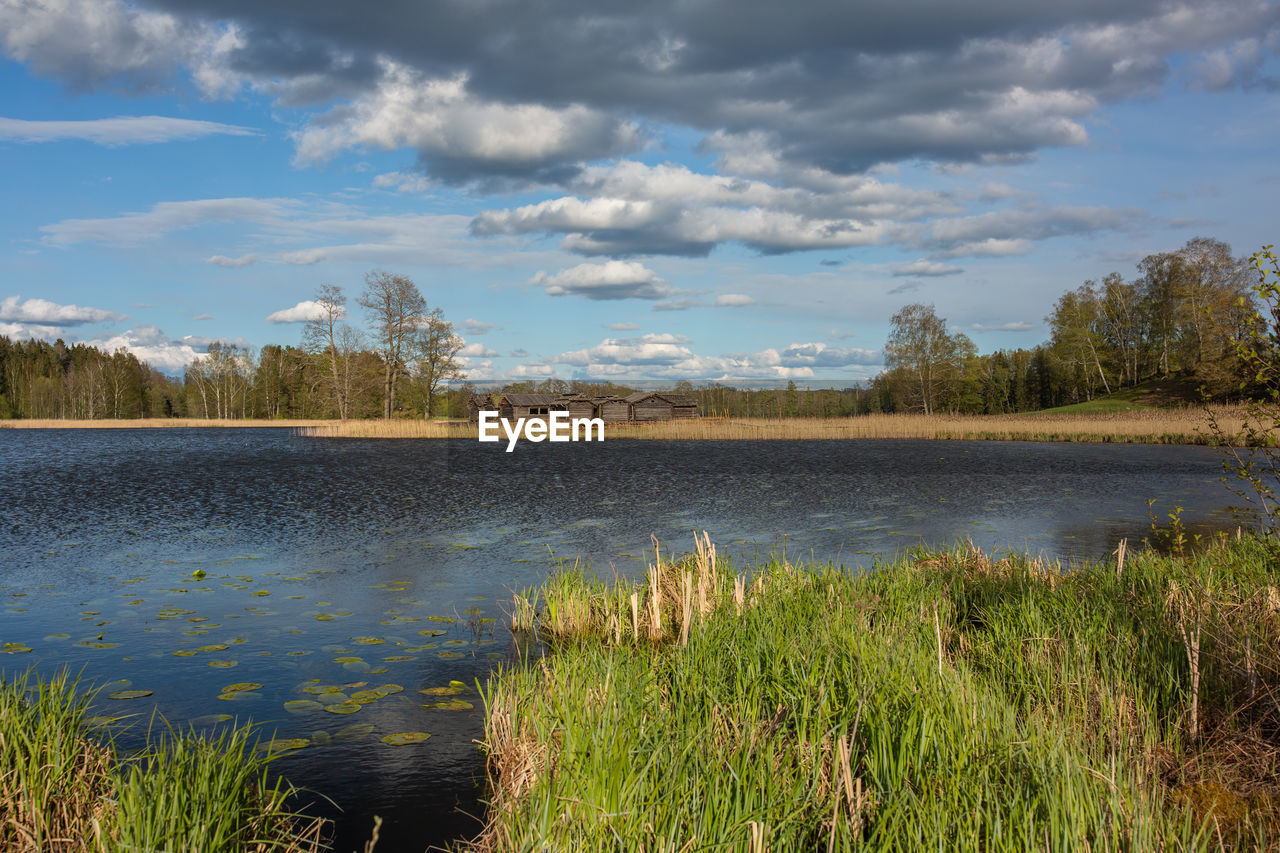 SCENIC VIEW OF LAKE AGAINST CLOUDY SKY