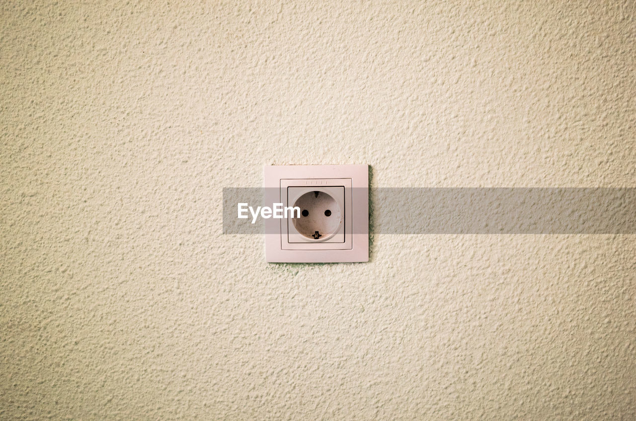 CLOSE-UP OF TELEPHONE BOOTH ON WALL AT HOME