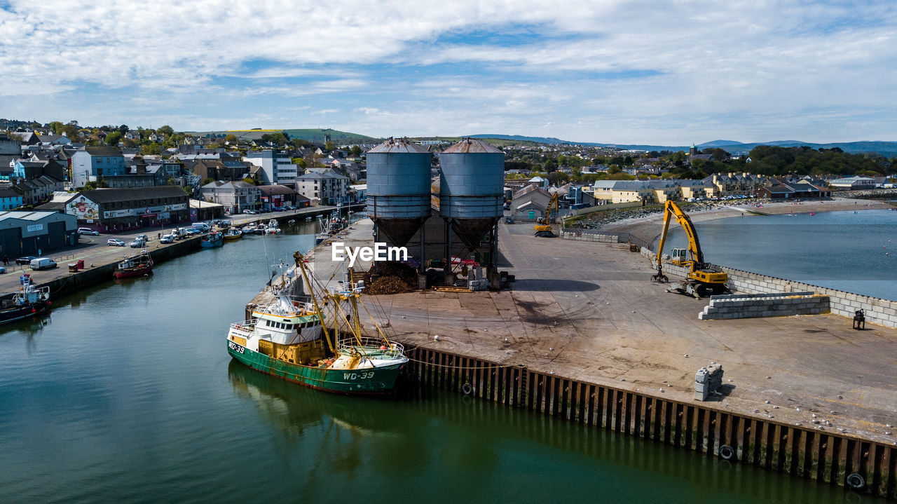 High angle view of boats moored at harbor in town