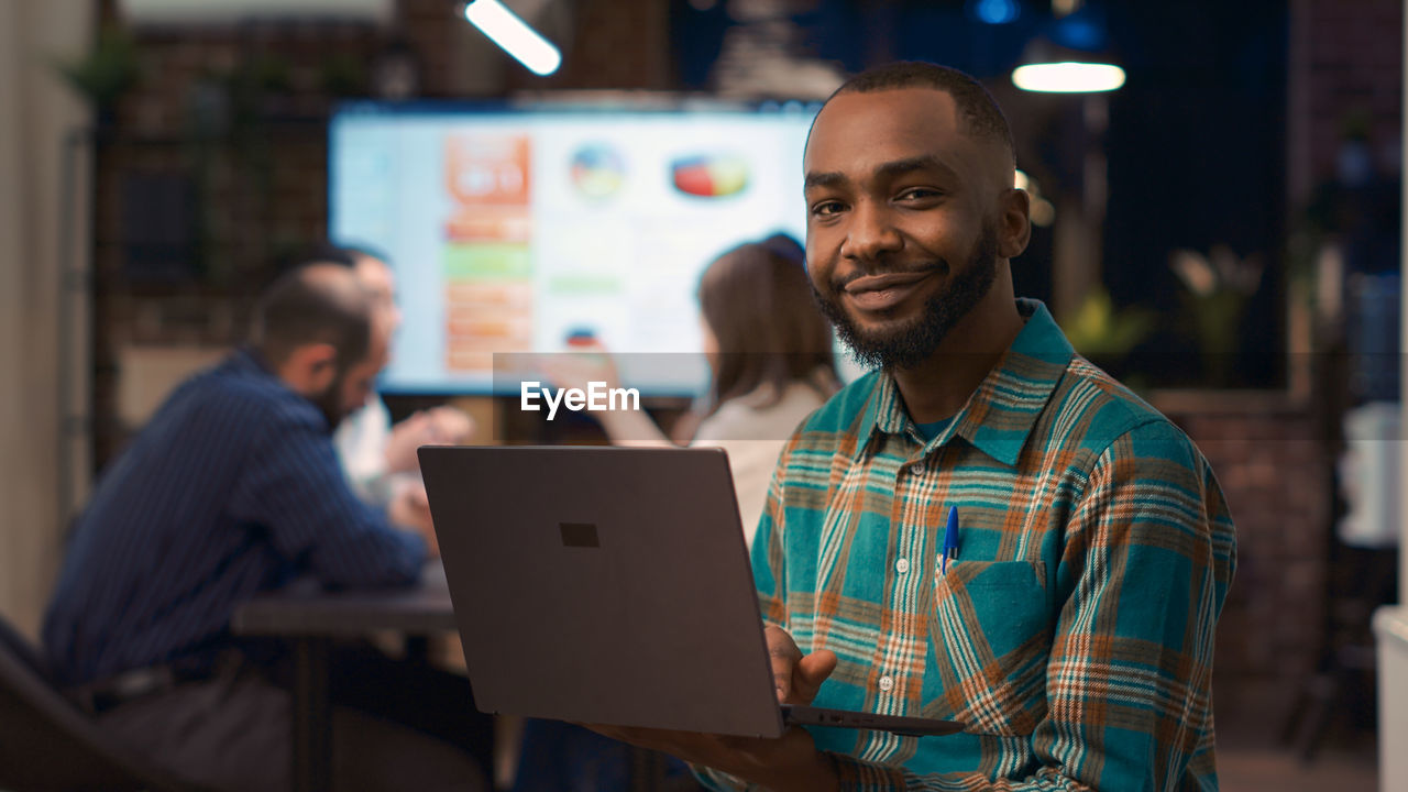 portrait of young man using laptop