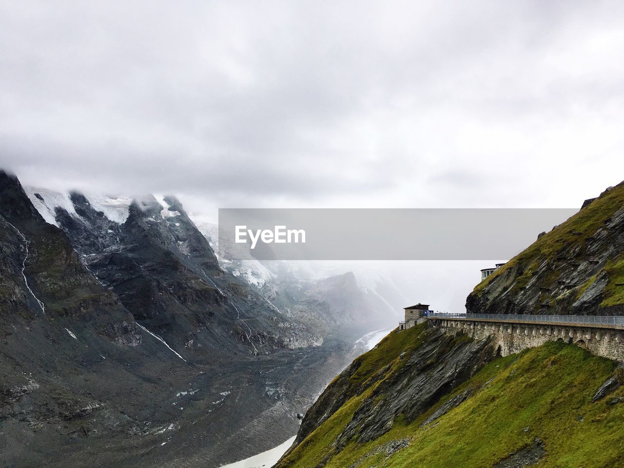 Scenic view of mountains against cloudy sky