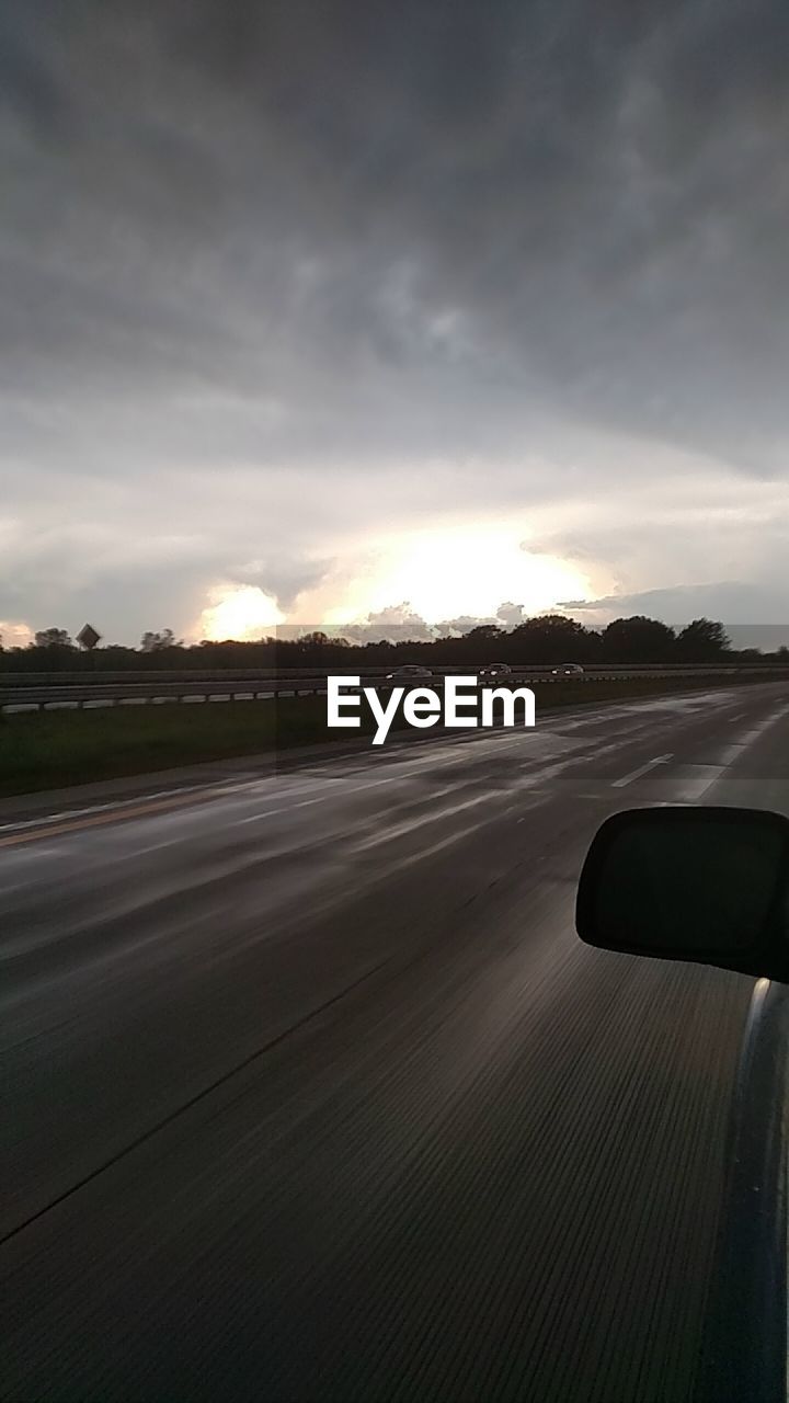 Car on road against sky during sunset