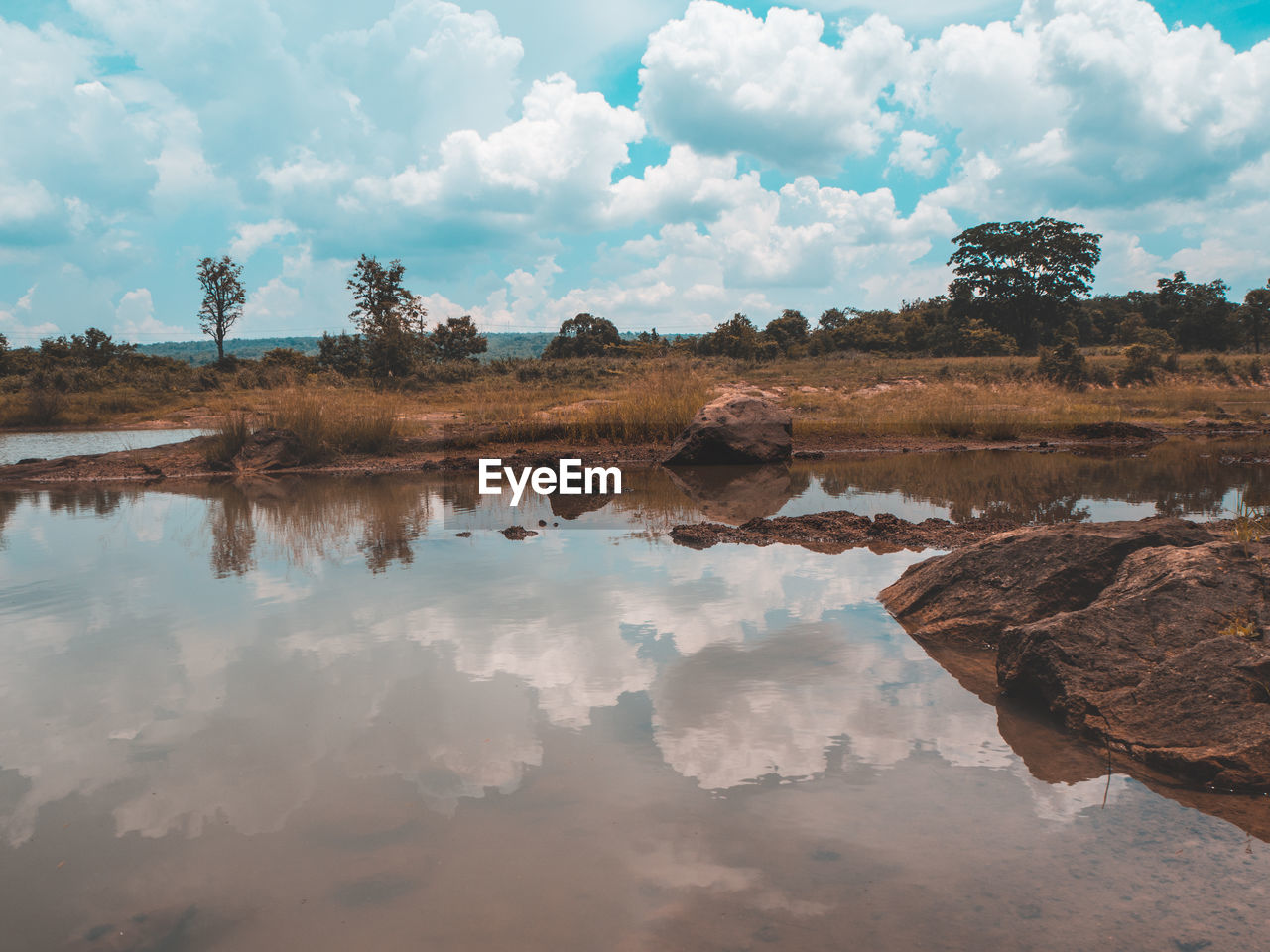 Scenic view of lake against cloudy sky