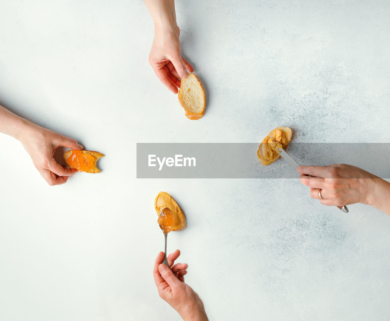 Female hands illustrating stages of making peanut butter and jelly sandwich. flat layout .