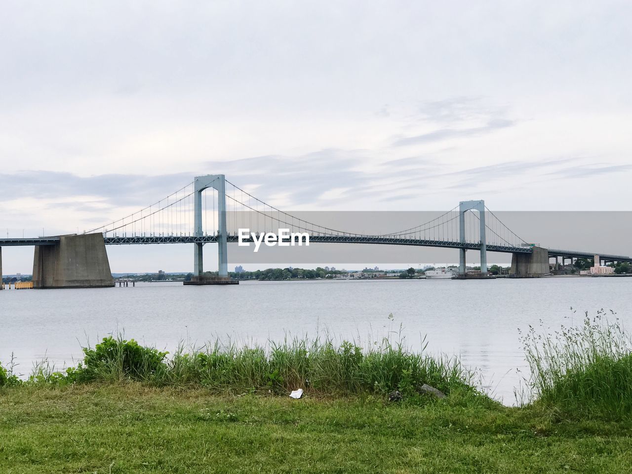 SUSPENSION BRIDGE OVER RIVER AGAINST SKY