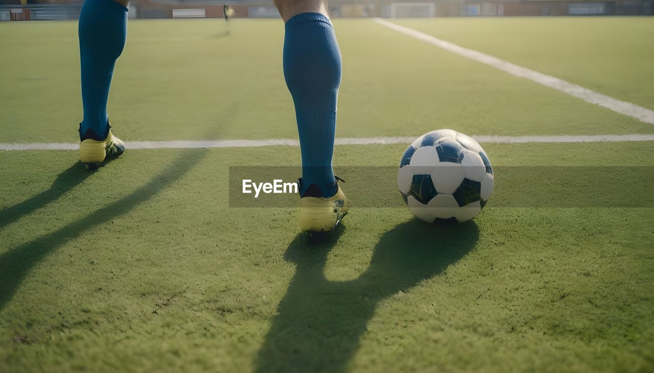 low section of man playing soccer