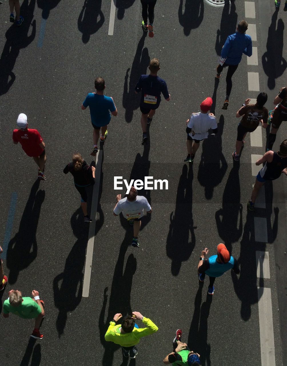 High angle view of runners running on street during marathon