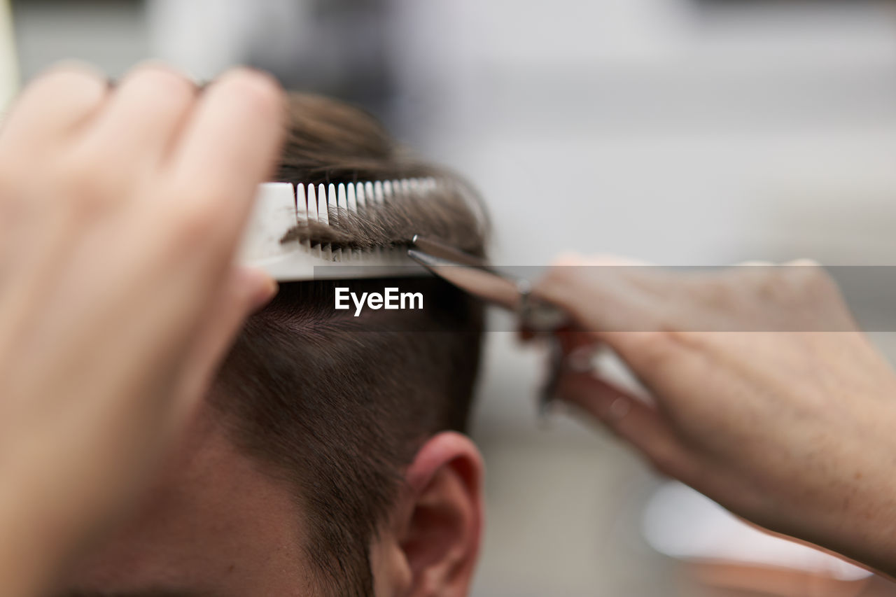 Close-up of man sitting in barber shop