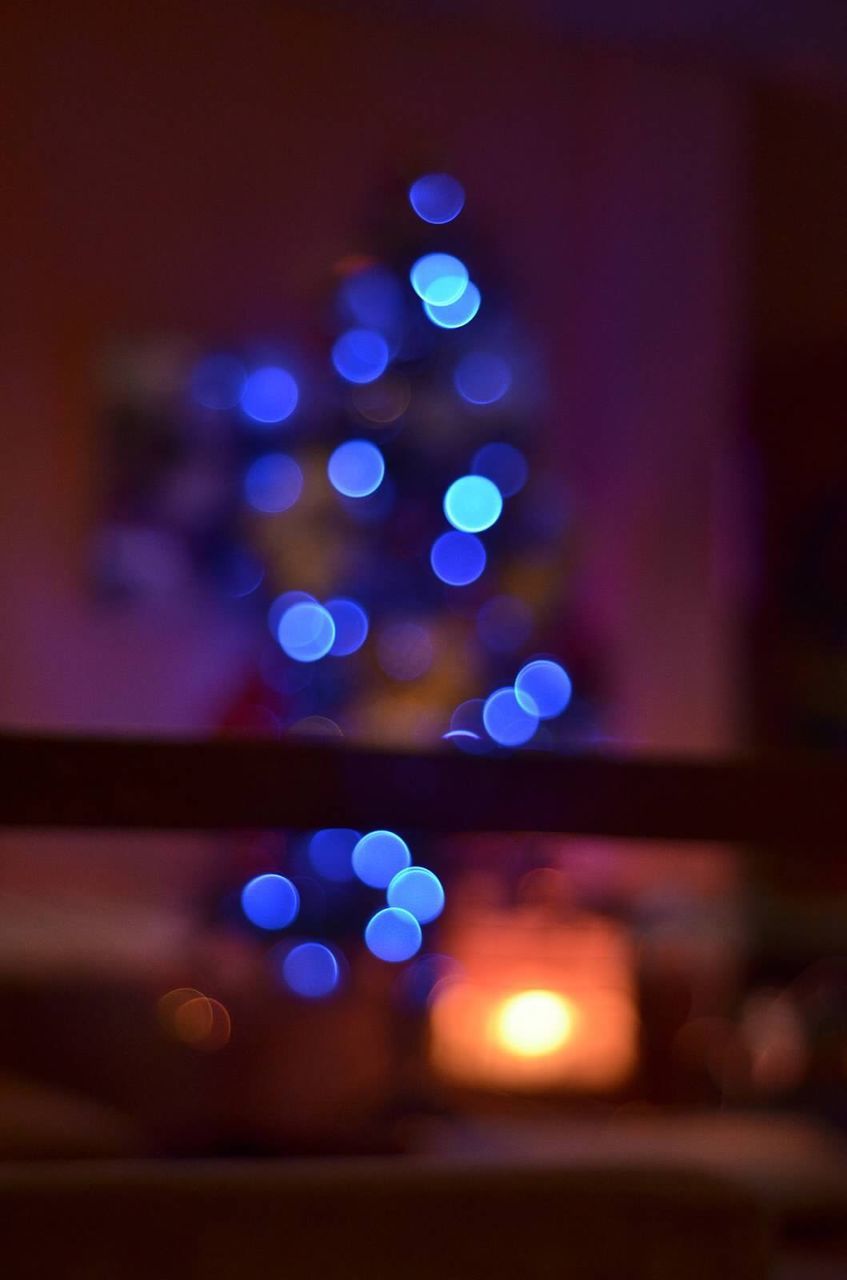Defocused image of illuminated christmas lights at home
