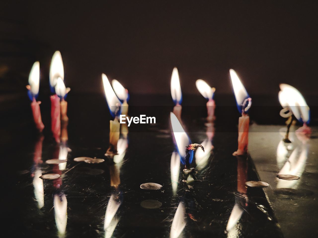 Close-up of burning candles on table