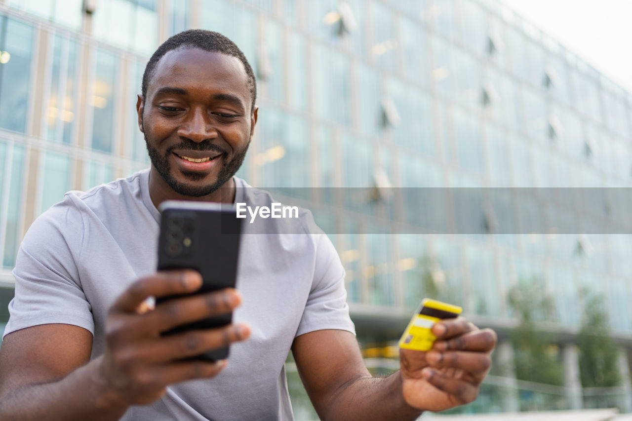 portrait of young man using mobile phone