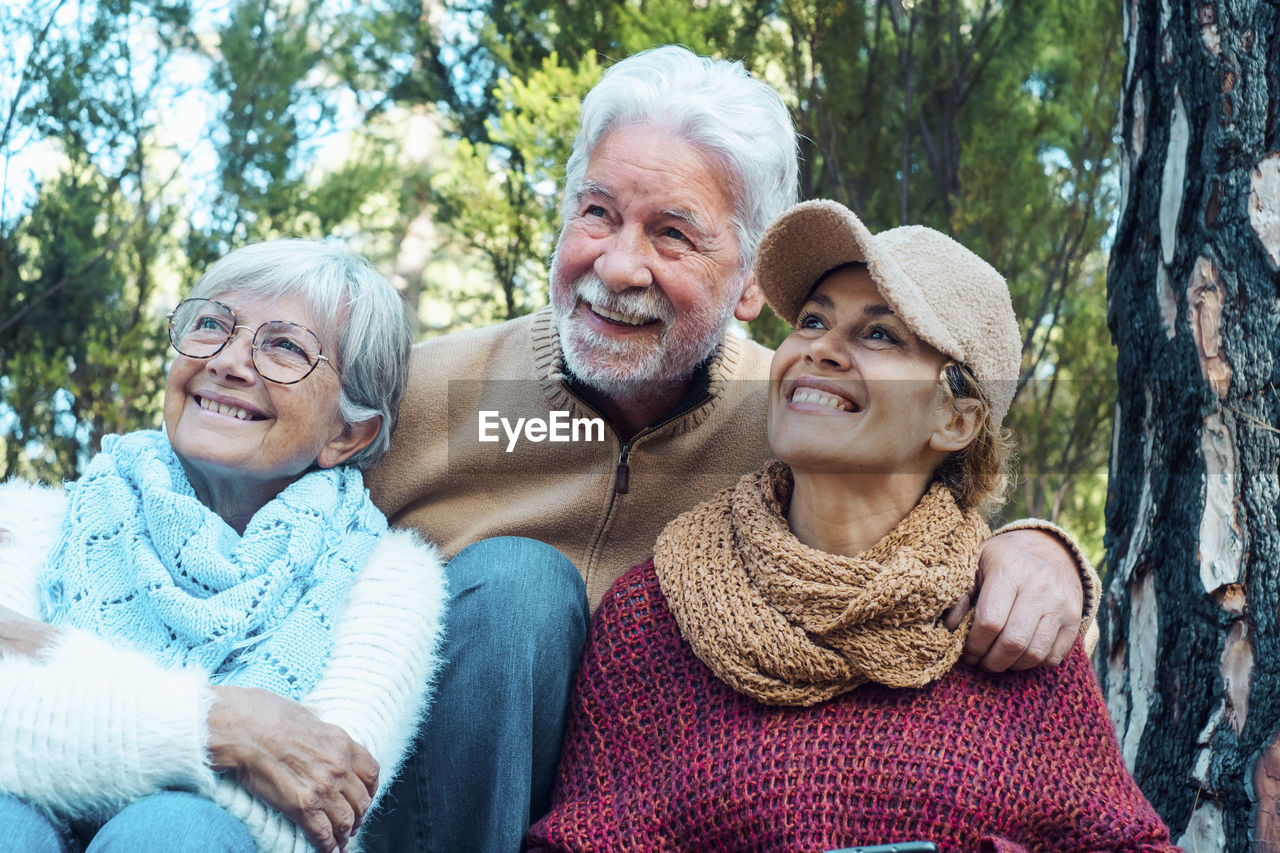 Happy family sitting together outdoors