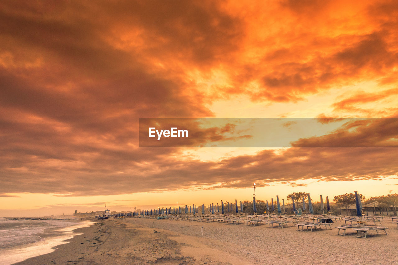 Scenic view of beach against sky during sunset